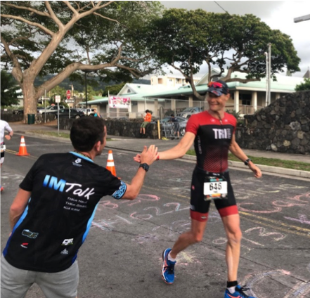 Passing my coach (and Podcaster-Supreme) near the finish line. I am smiling as I know it is nearly over.